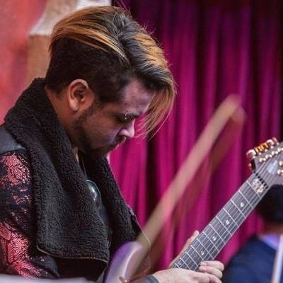 Chris playing guitar on stage
